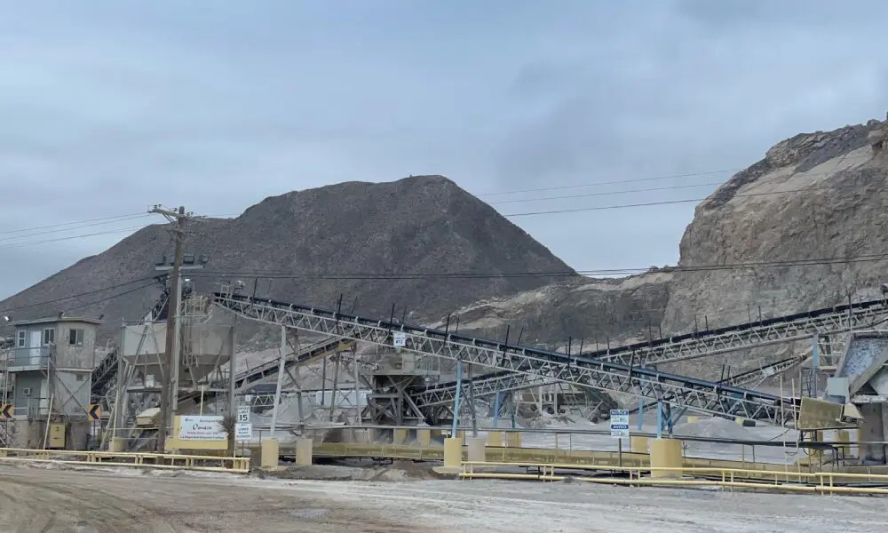 A large industrial area with mountains in the background.