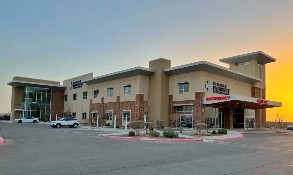 A large building with cars parked in front of it.