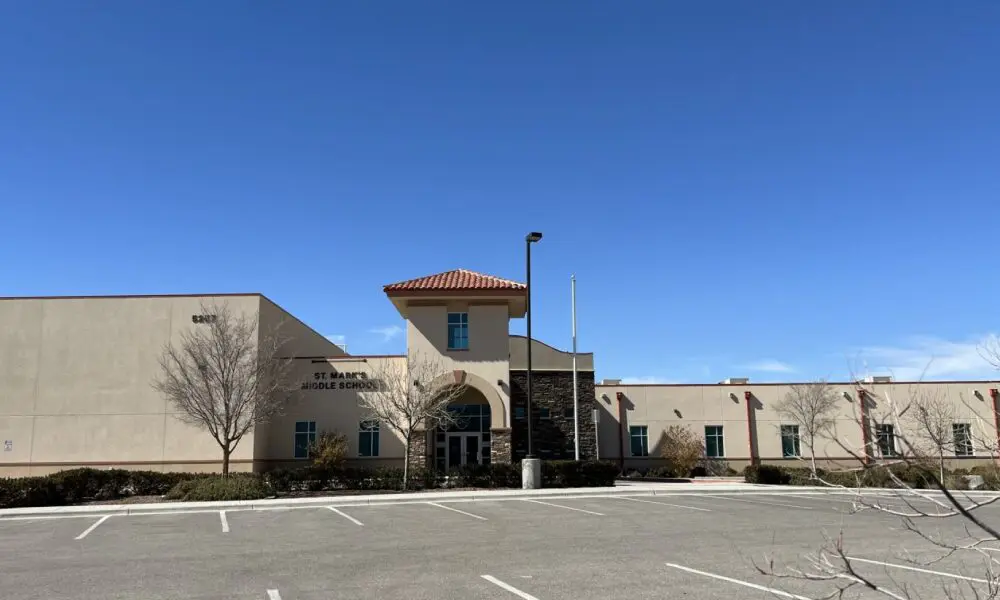 A large building with a parking lot in front of it.