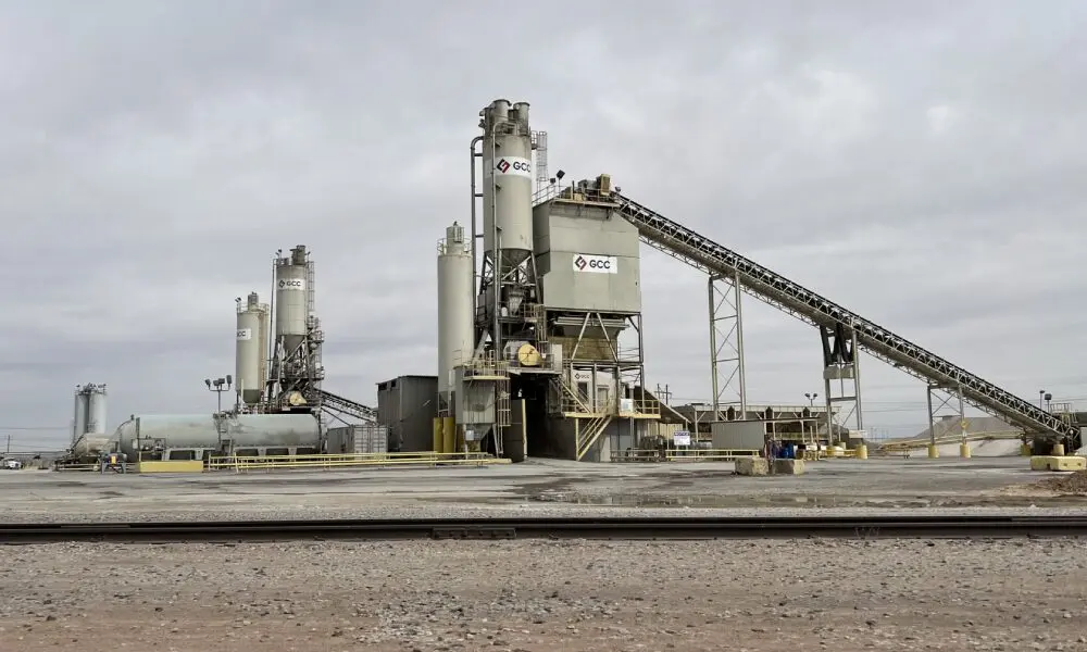 A cement plant with many workers and machinery.