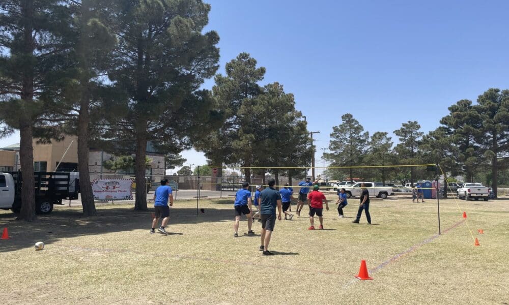 A group of people playing frisbee golf in the park.