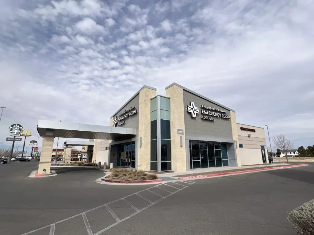 A large building with a cross on the front of it.