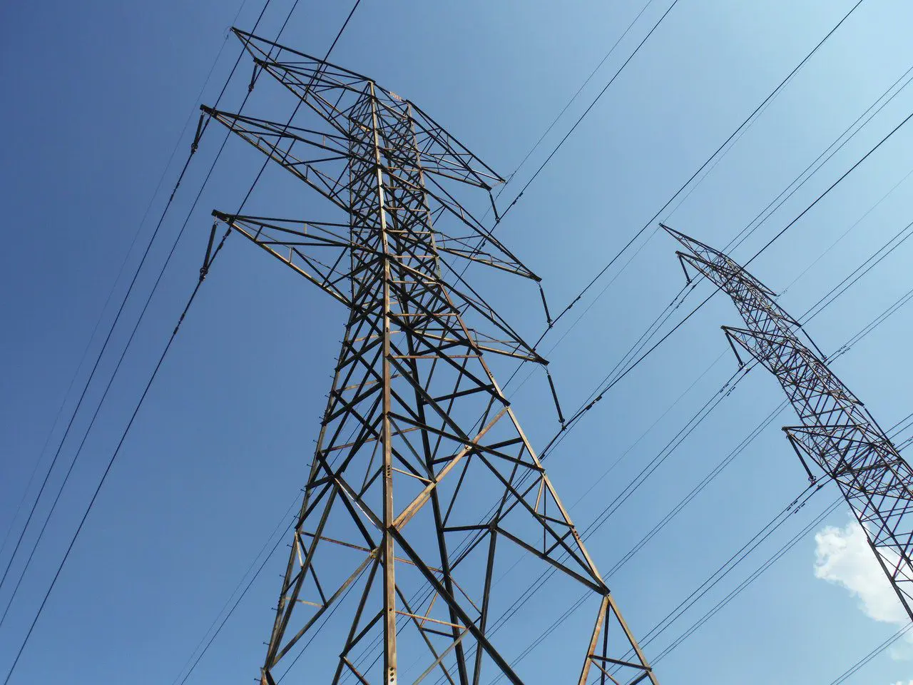 A power line tower with many wires on it.